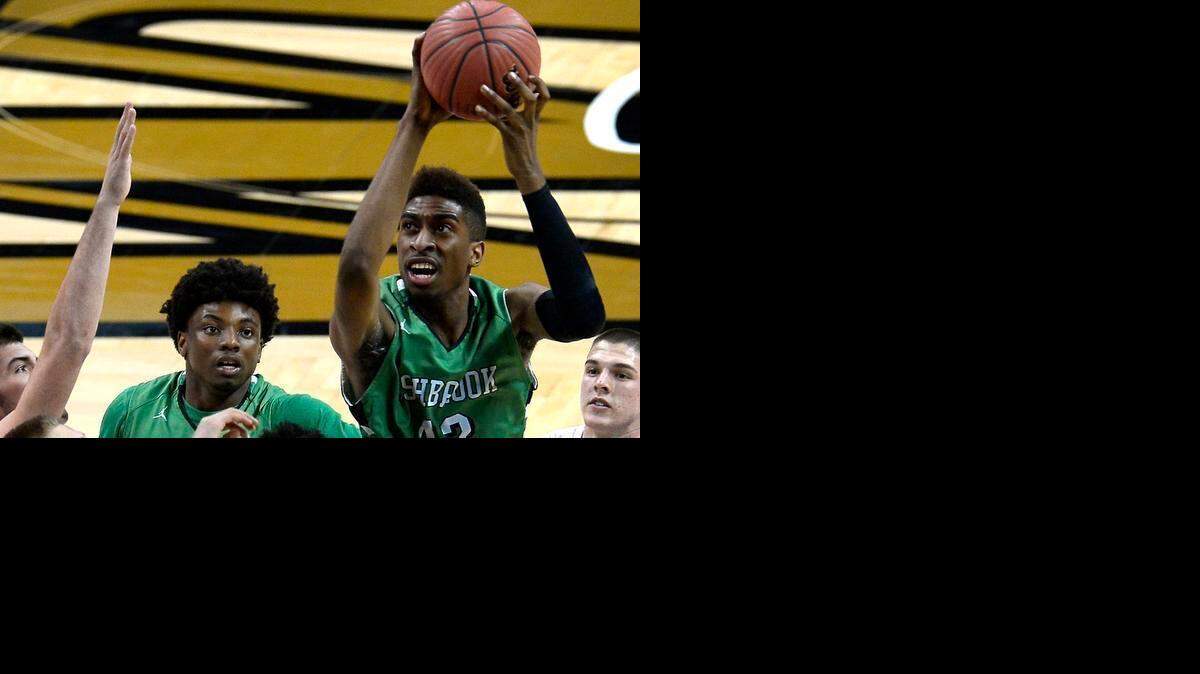 
Ashbrook's Isaiah Whaley (42) fights to get a shot off in the lane during first-half action against Ledford in NC 3 Western Regional semifinals action on Thursday, March 5, 2015 at Lawrence Joel Coliseum in Winston-Salem. Ashbrook defeated Ledford 66-44.
