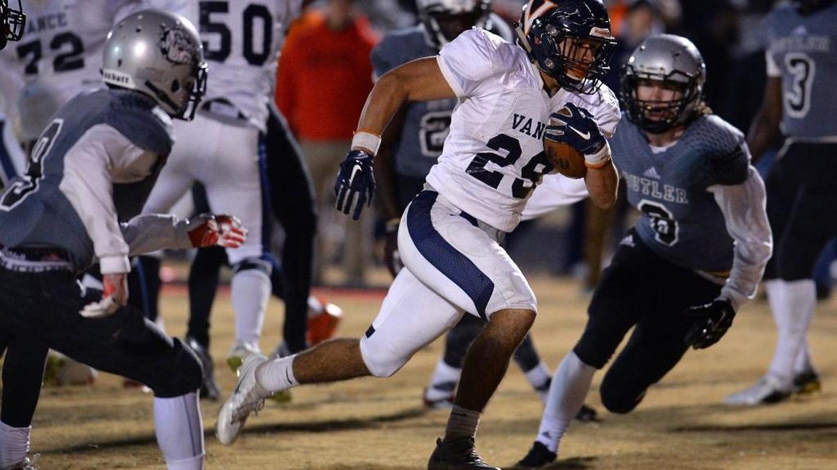 With under 50-seconds remaining in fourth quarter action, Vance Cougars running back Kalen Clark, center, rushes up the middle for a touchdown against the Butler Bulldogs at Butler High School on Friday, December 2, 2016. With Clark's score, Butler led 42-41 prior to the made field goal tying the game. Vance would defeated Butler 50-49 in overtime on a two-point conversion run by quarterback Kingsley Ifedi.