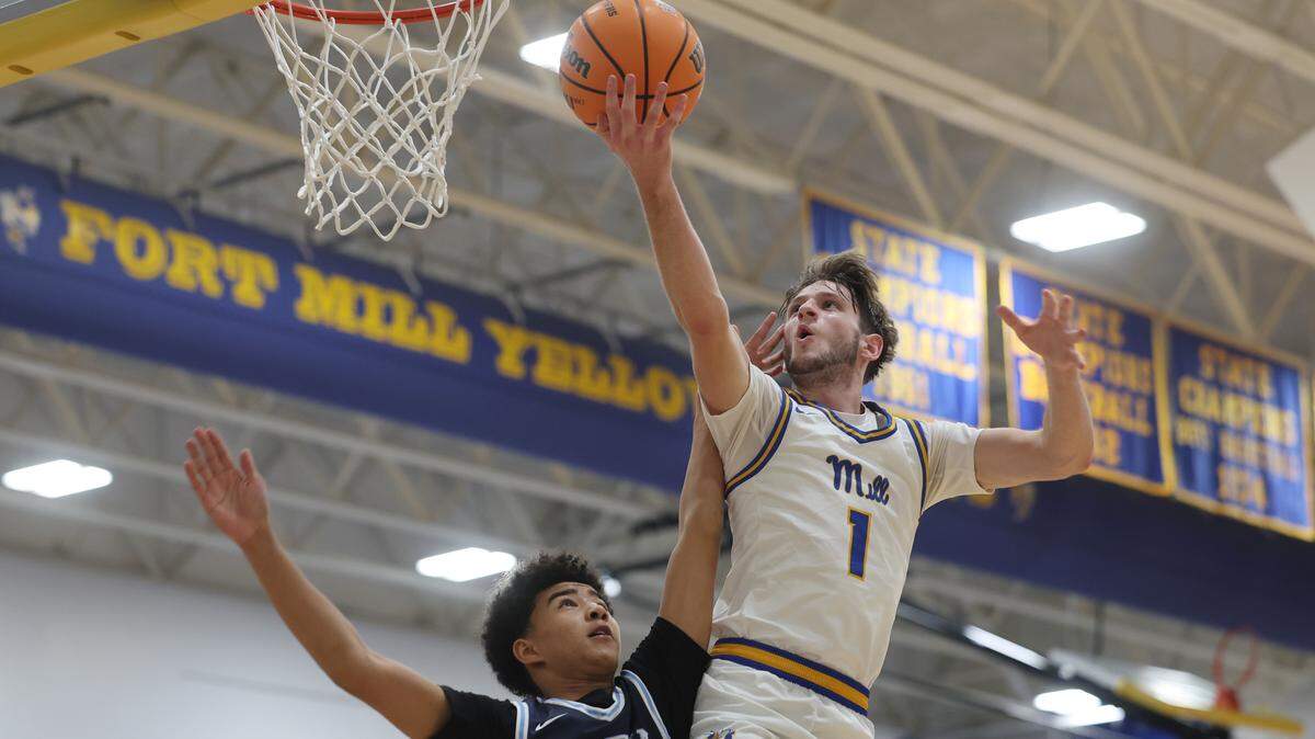 Fort Mill High School's Evan Jones put up the shot while Charlotte Latin's Emory Chaney puts pressure on him Tuesday, Nov. 25, 2025 in Fort Mill, S.C.