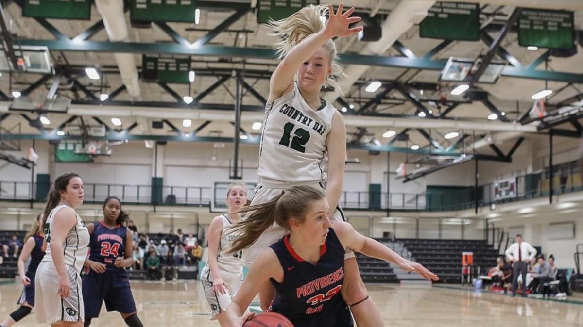 Providence Day’s Andi Levitz ducks underneath Country Day’s Caroline Kosmicki for a two-point basket during Friday’s game.