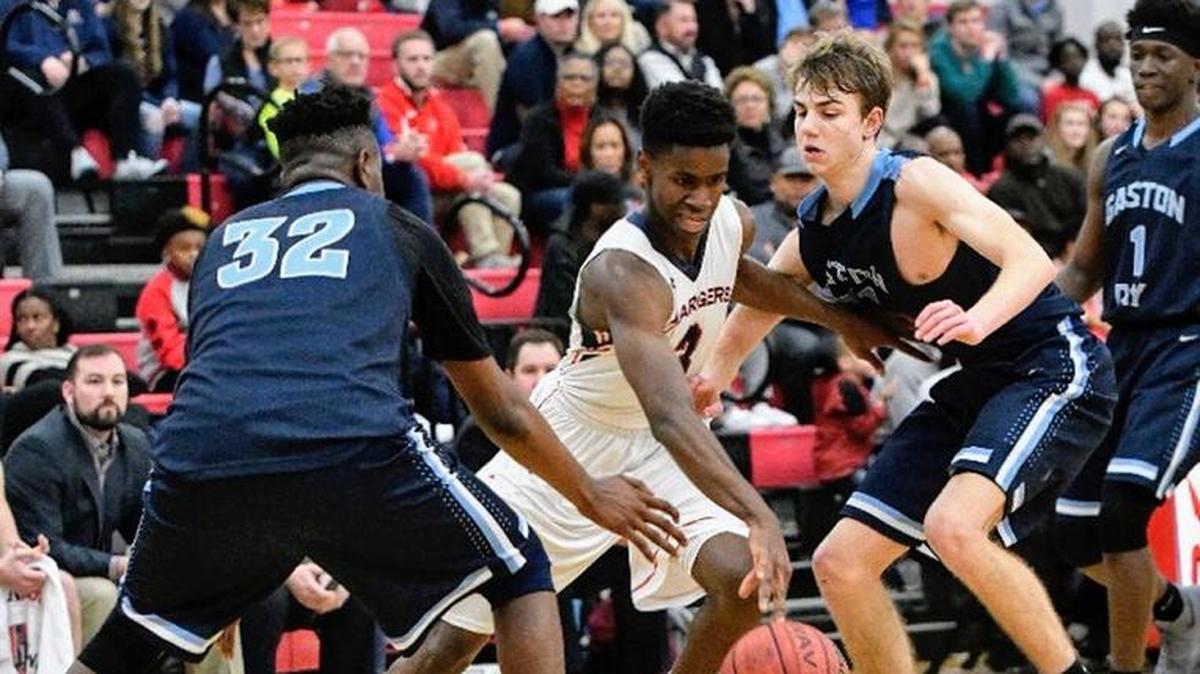Providence Day’s Trey Wertz splits defenders in the Chargers’ 82-74 win over Gaston Day at the Charlotte Hoops Challenge Friday