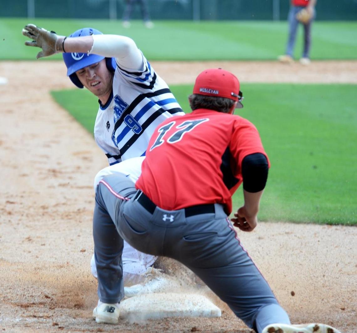 Charlotte Christian #9 Jonathan Jagielski slides safely into third base as Wesleyan Christian Academy #17 Nick Caldwell tries to make the tag out during Saturday's championship baseball game. Wesleyan Christian Academy defeated Charlotte Christian in the NCISAA 3A state championship baseball game at Charlotte Country Day Saturday afternoon.