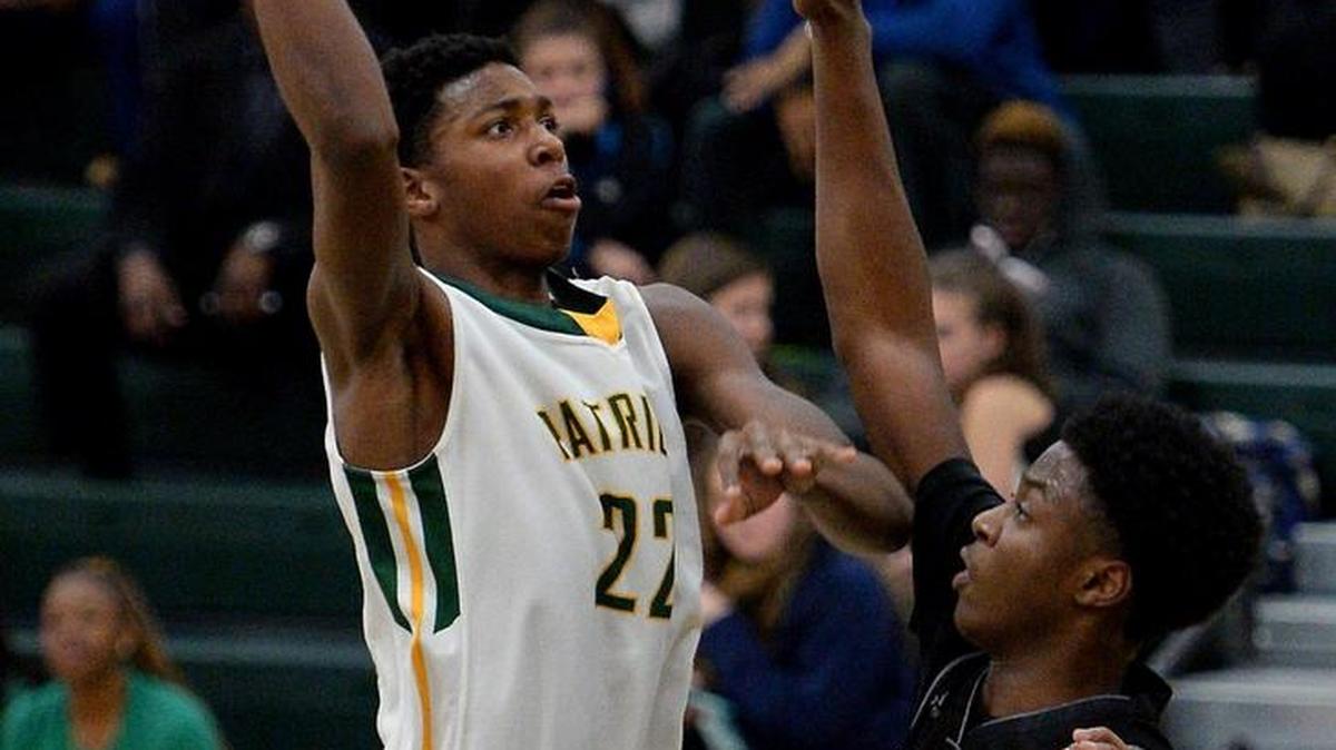 Independence Patriots Justyn Hamilton releases a one-handed shot in the lane over Butler Bulldogs Jah'lil Carter during second half action at Independence High School on Tuesday, January 19, 2016. Independence defeated Butler 50-45.