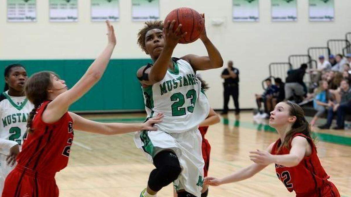 
Myers Park guard Aliyah Mazyck (23) drives between two Greensboro Page defenders for a shot during first half action on Monday. Myers Park defeated Greensboro Page 74-32.
