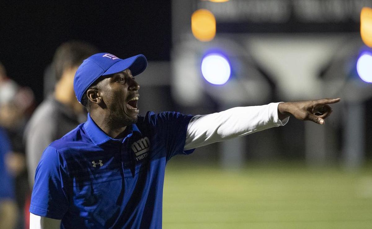 North Mecklenburg coach Eric Morman shouts instructions to his players in Friday’s football game at Hough.