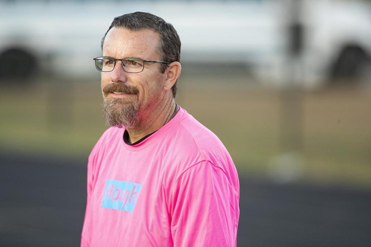 Hough football coach Matthew Jenkins watches his Huskies warm up before facing North Mecklenburg at Hough Friday night.