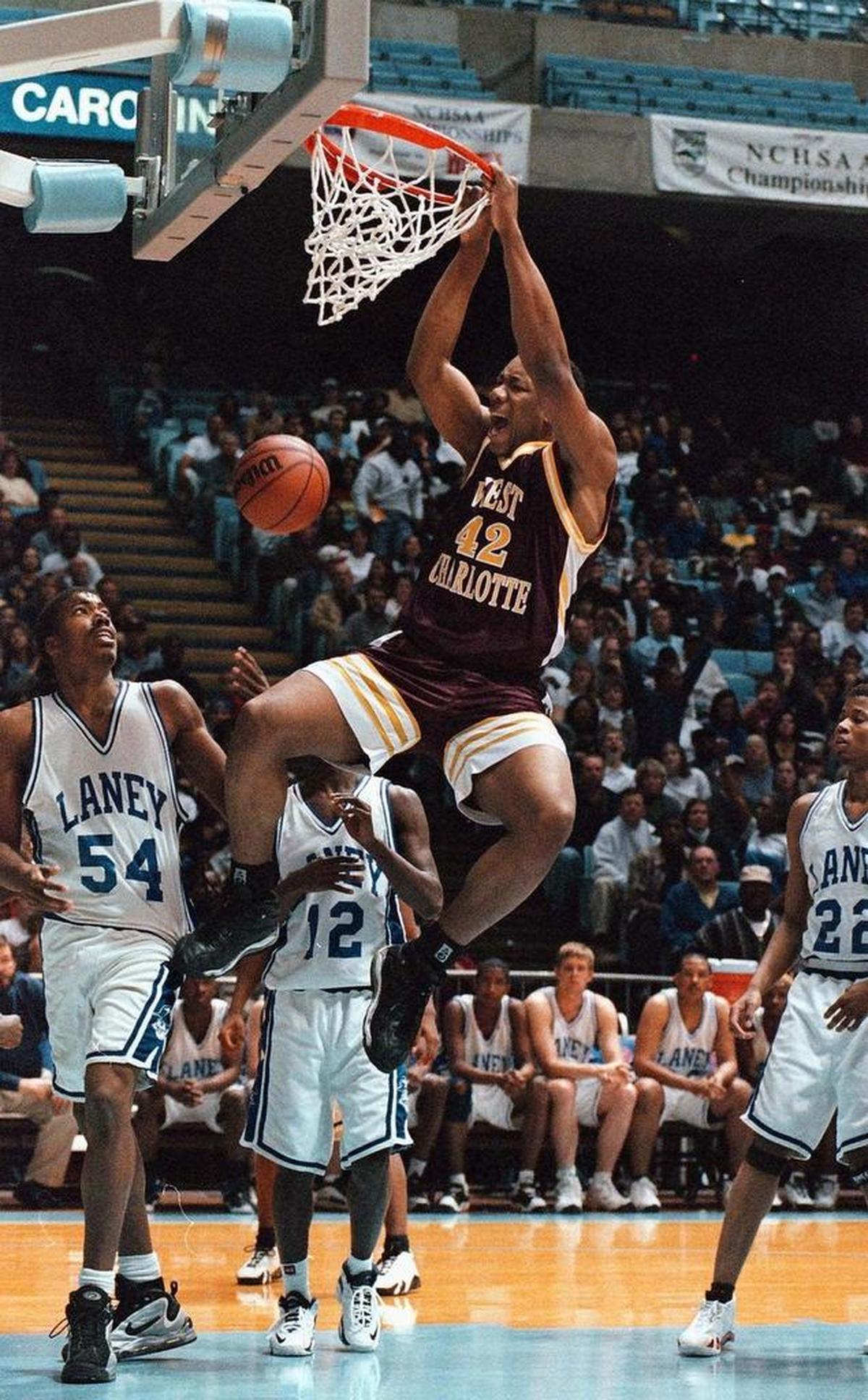 West Charlotte's Jason Parker (42) dunks over Wilmington Laney defenders during the N.C. 4A boys’ championship game in March 1999 at the Smith Center in Chapel Hill.
