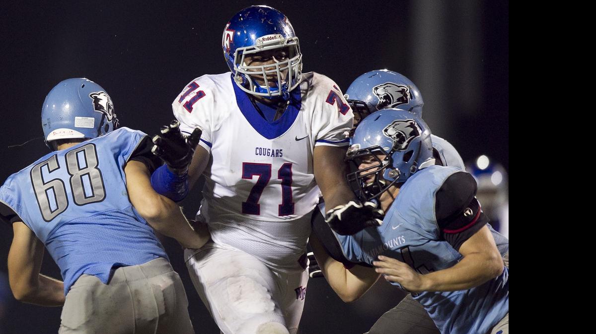 
Wake Forest defensive lineman Dexter Lawrence (71) breaks through the Panther Creek offensive line in game last August. Lawrence, 6-5 and 335 pounds, is ranked No. 1 by Rivals in the class of 2016
