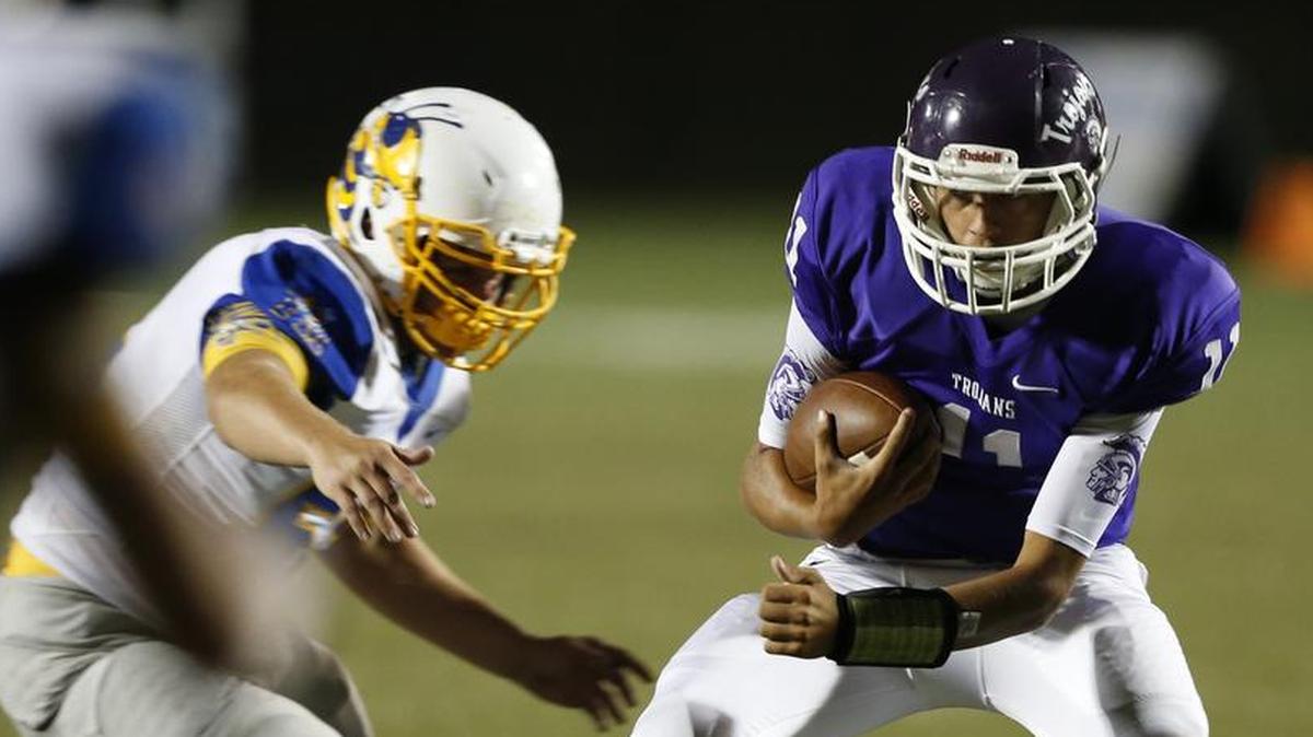 Northwestern quarterback Dustin Noller, right, and the Trojans will visit reigning 5A state champion Dutch Fork on Friday.