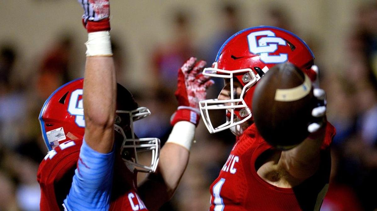 Charlotte Catholic running back Michael Neel, left, congratulates tight end/wide receiver Jon Newman, right, after Newman rushed into the end zone for a touchdown following a pass reception from quarterback Brady Berger during second quarter action against Ardrey Kell on Friday, October 28, 2016 at Charlotte Catholic.
