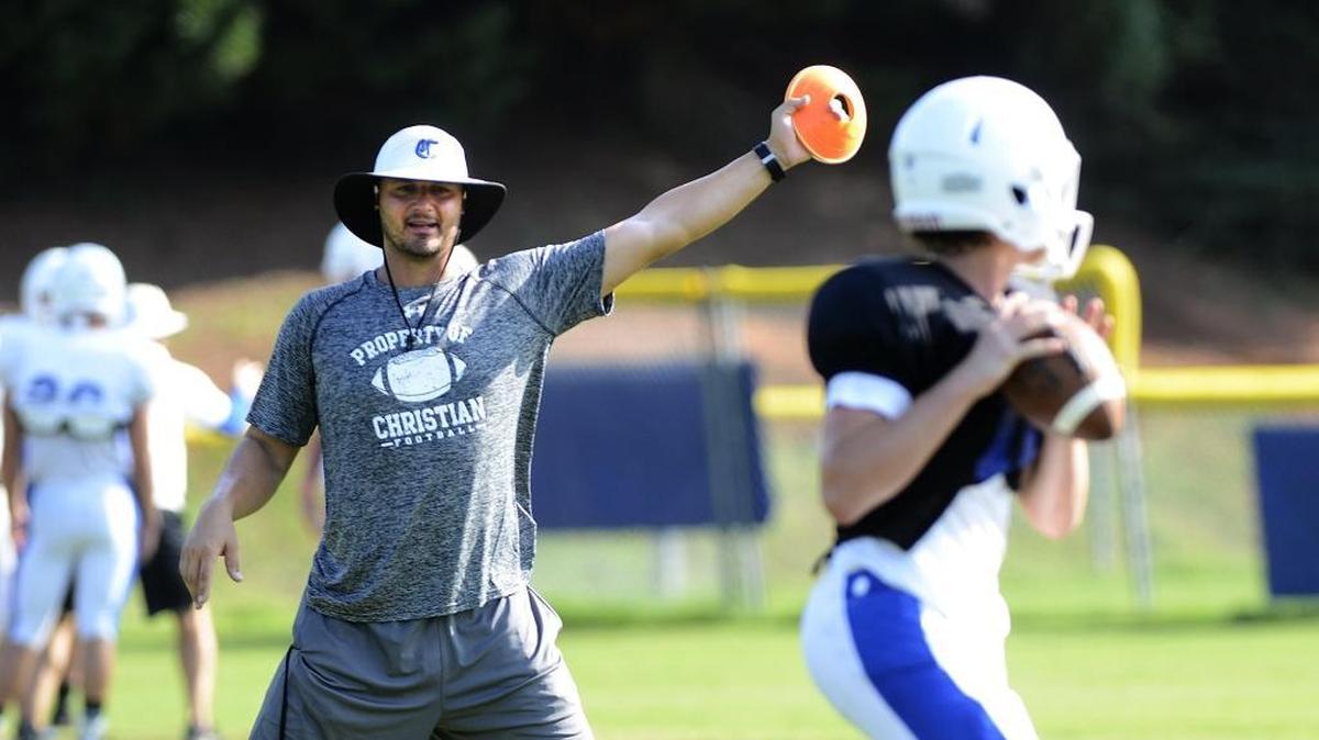 
No. 12 Charlotte Christian hunts a school-record fourth straight private schools state title under coach Jason Estep. Estep worked with quarterback Jack Cherry during a recent practice.


