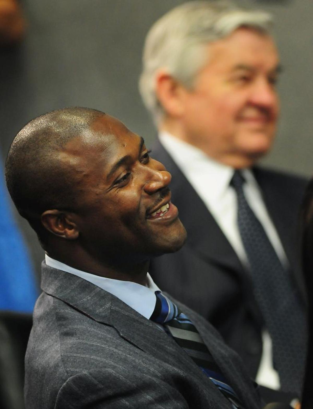Journey Muhammad’s father is former Carolina Panthers wide receiver Muhsin Muhammad, left, with team owner Jerry Richardson, during a program announcing his retirement in June 2010.