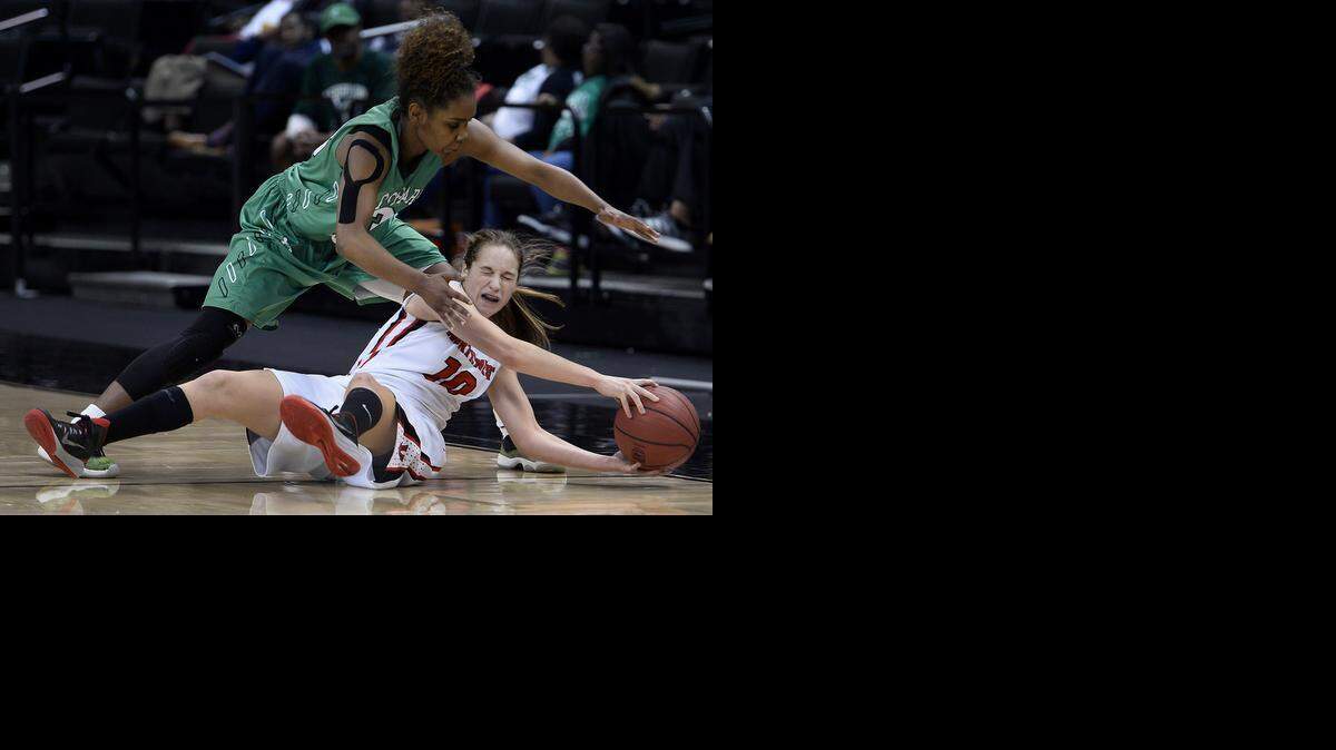 
Myers Park's Aliyah Mazyck applies defensive pressure on Northwest Guilford's Hayley Barber as she falls to the floor at Lawrence Joel Veterans Memorial Coliseum in Winston-Salem. Myers Park defeated Northwest Guilford 58-38 in the NCHSAA Western Regional Championship game.
