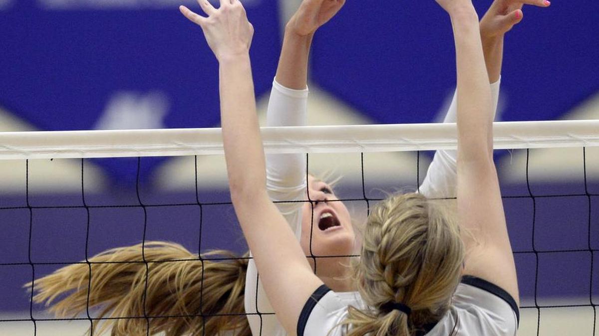 Ardrey Kell’s Maddie Sweeney and Providence’s Riley Outen (14) meet at the net during their volleyball match Wednesday at Ardrey Kell High. Providence won 25-14, 25-16, 23-25, 25-27, 15-12.