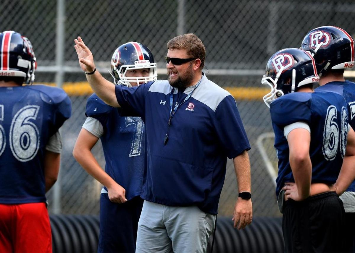 Providence Day head coach Adam Hastings gives instructions to the players during practice on Tuesday, September 19, 2017.