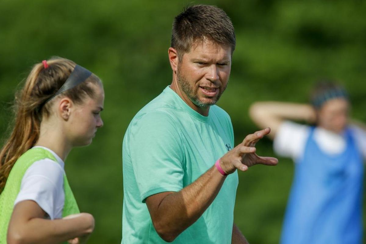 Myers Park soccer coach Bucky McCarley, right, chats with midfielder Olivia Hollidge.