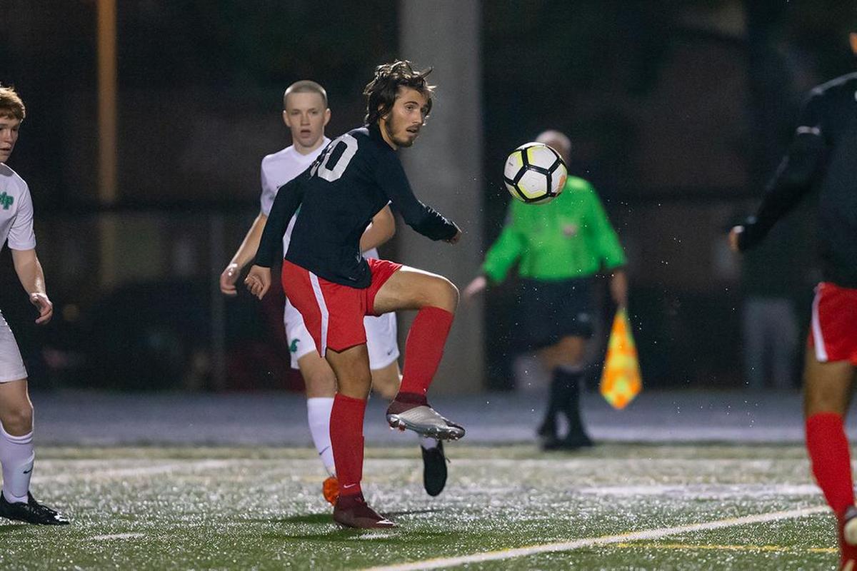 South Meck’s Nick Alliota (center) looks to cross the ball during early first half action.
