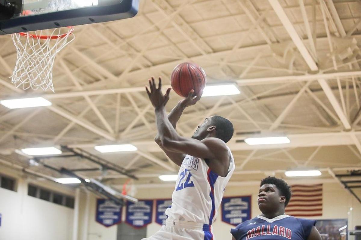 Jabril Griffin (22) of North Meck, shoots a one-handed floater down the baseline during late second-quarter action. The North Meck Vikings hosted the Mallard Creek Mavericks on Friday, Jan. 5, 2018.