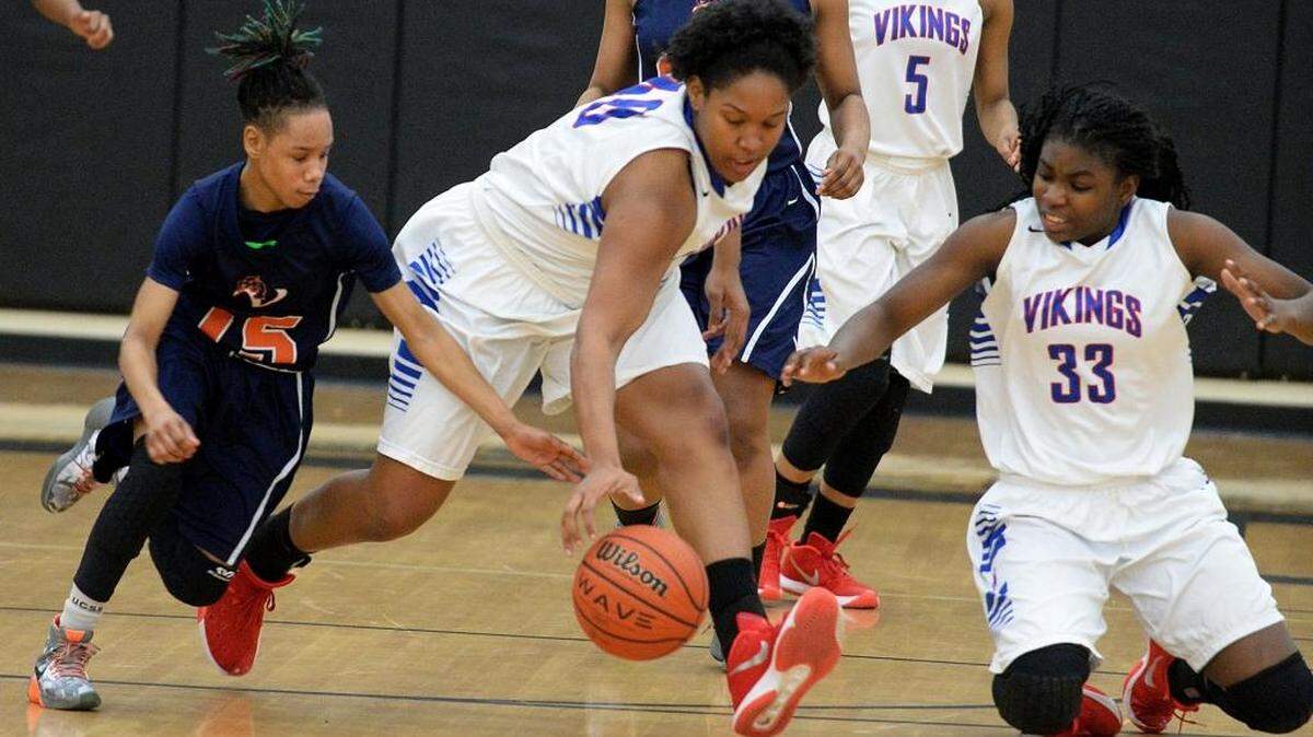 Vance’s Aire Richardson, left, and North Mecklenburg’s Monell Dunlap and Nazhiyah Hayes (33) scramble for a loose ball during a MECKA 4A girls’ basketball tournament game Wednesday at Hough High. North Meck won 66-56.