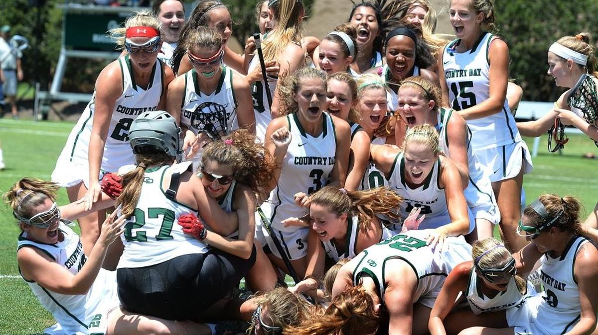 The Charlotte Country Day girls lacrosse team celebrates their win over Charlotte Latin at the NC Independent Schools state girls lacrosse championship Saturday at Country Day.