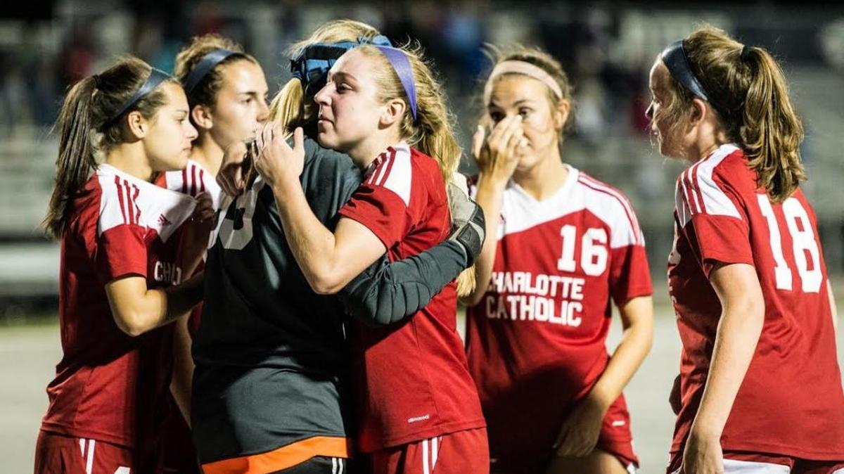 Charlotte Catholic sophomore Grace Wielechowski consoles senior goalkeeper Amanda Rock after their loss to West Forsyth in the NCHSAA Class 4-A girls semifinal soccer game Thursday evening, May 25, 2017 at Pine Lake Prep Athletic Complex in Mooresville, N.C. The Titans defeated the Cougars, 4-3, in penalty kicks.(Winston-Salem Journal/Allison Lee Isley)20170526w_spt_catholicwestsoccer