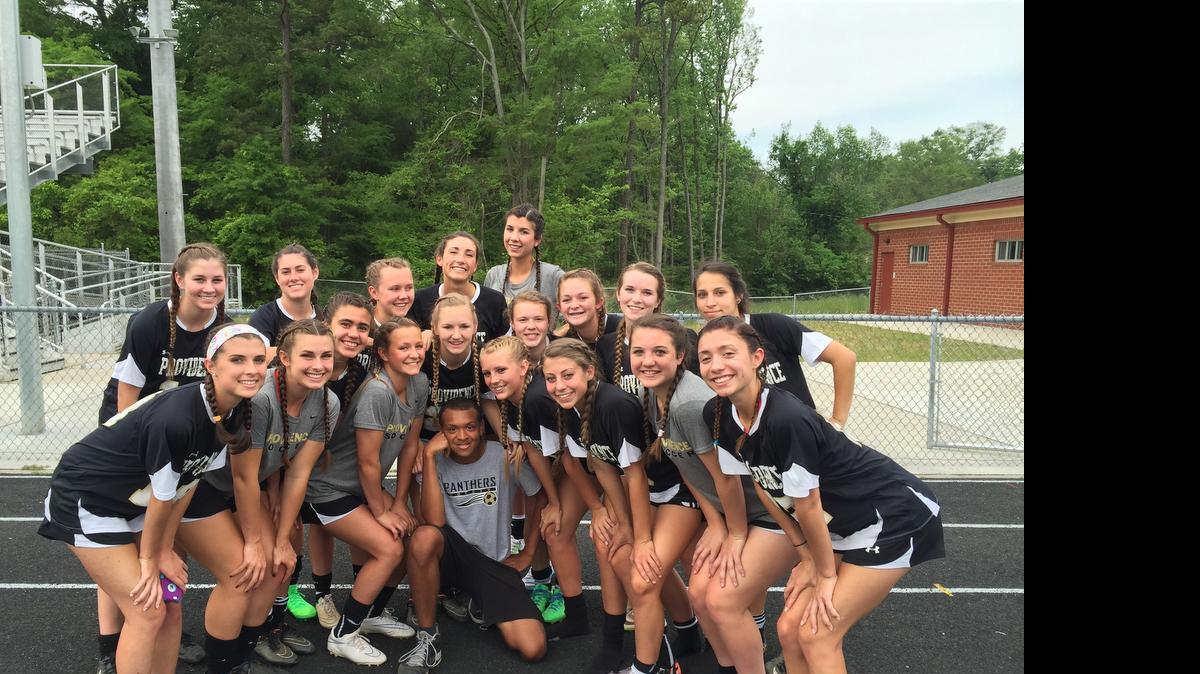 
Darius Johnson, center, with the Providence High School girls’ soccer team. Johnson, who has autism, serves as the team’s manager. Players say he is a source of motivation and helps them keep things in proper perspective.

