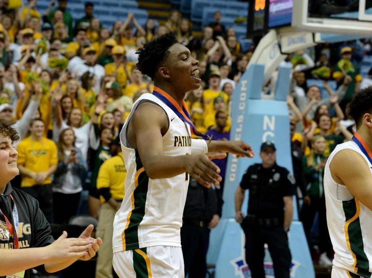 Independence players including # 1 Matt Smith celebrate winning the state championship over Heritage after Saturday evening's NCHSAA state basketball championship 4A game between Independence and Wake Forest Heritage at the Smith Center in Chapel Hill.