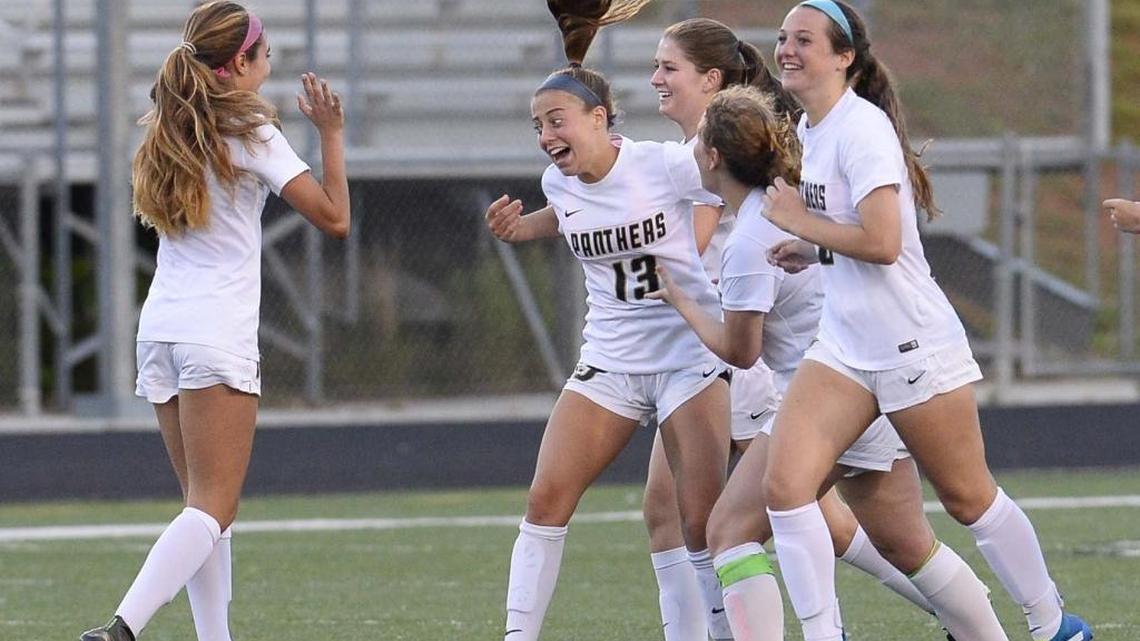 Providence’s Abigail Schomburg in center, celebrates a goal against Hough during Wednesday night's third-round playoff match played at Rocky River High on May 18, 2016. Providence won 2-0.