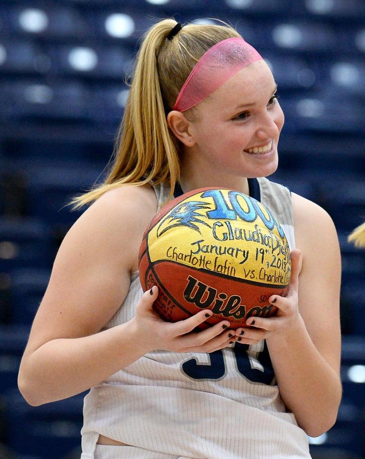 Charlotte Latin's Claudia Dickey smiles after being presented with a basketball recognizing her 1,000th career point. Charlotte Latin defeated Charlotte Country Day School 62-39 on Monday, January 22, 2018 at Charlotte Latin School.