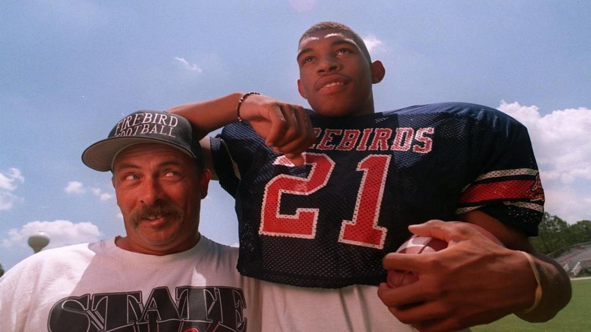 In high school at Southern Nash, Julius Peppers was a 6-foot-7, 240-pound running back. He’s pictured here clowning with coach Ray Davis.