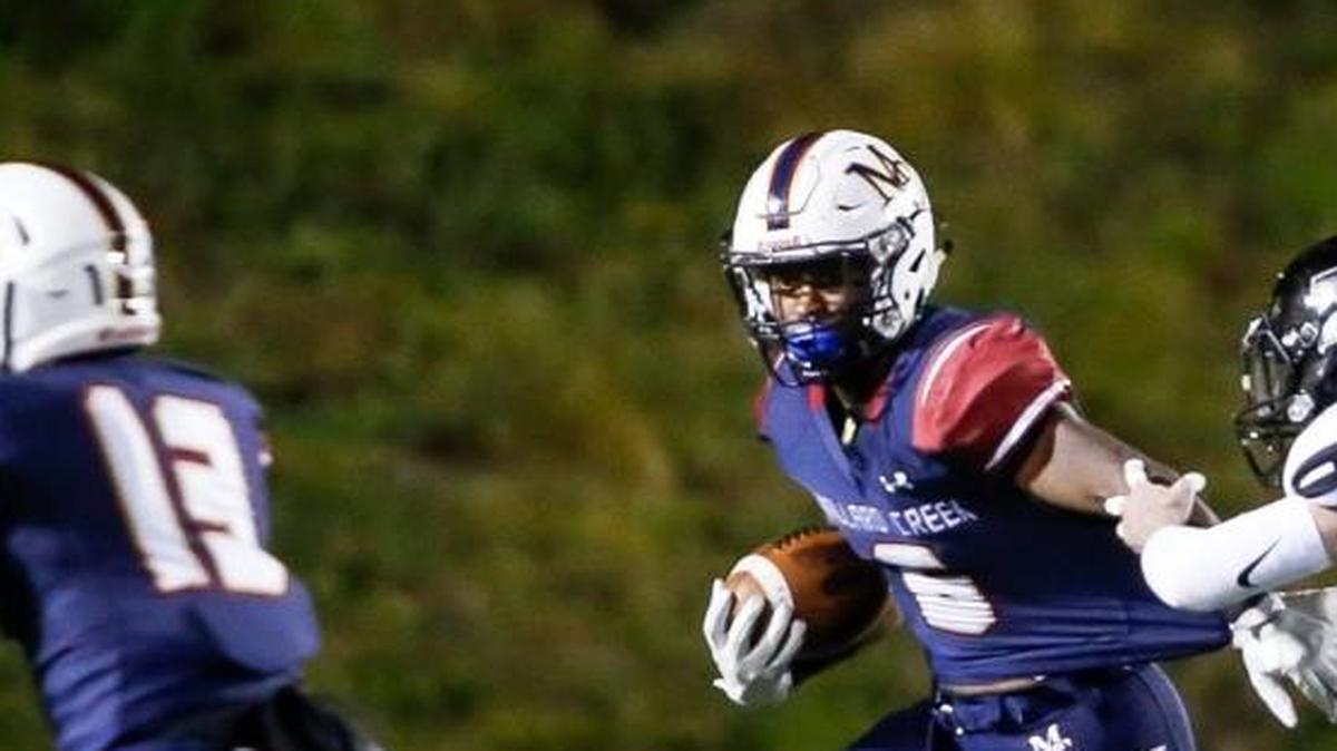 Mallard Creek's Nasjzae Bryant, left, tries to pull away from Hough's Will Fording during Friday’s 4AA region final at Mallard Creek. Bryant Rushed for 96 yards on 20 carries and scored twice in the third quarter.