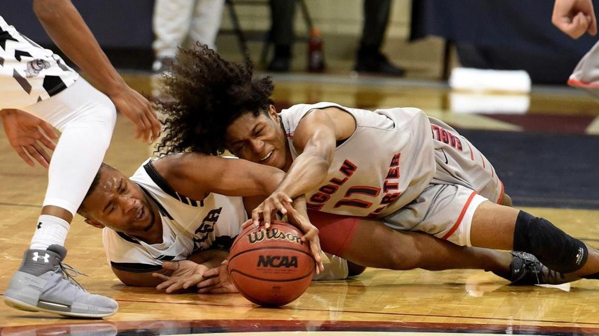 Butler’s D.J. Little (3) and Lincoln Charter’s Levontae Knox (11) fight for a loose ball in Friday night’s Hoodie’s House national tournament game at Providence Day.