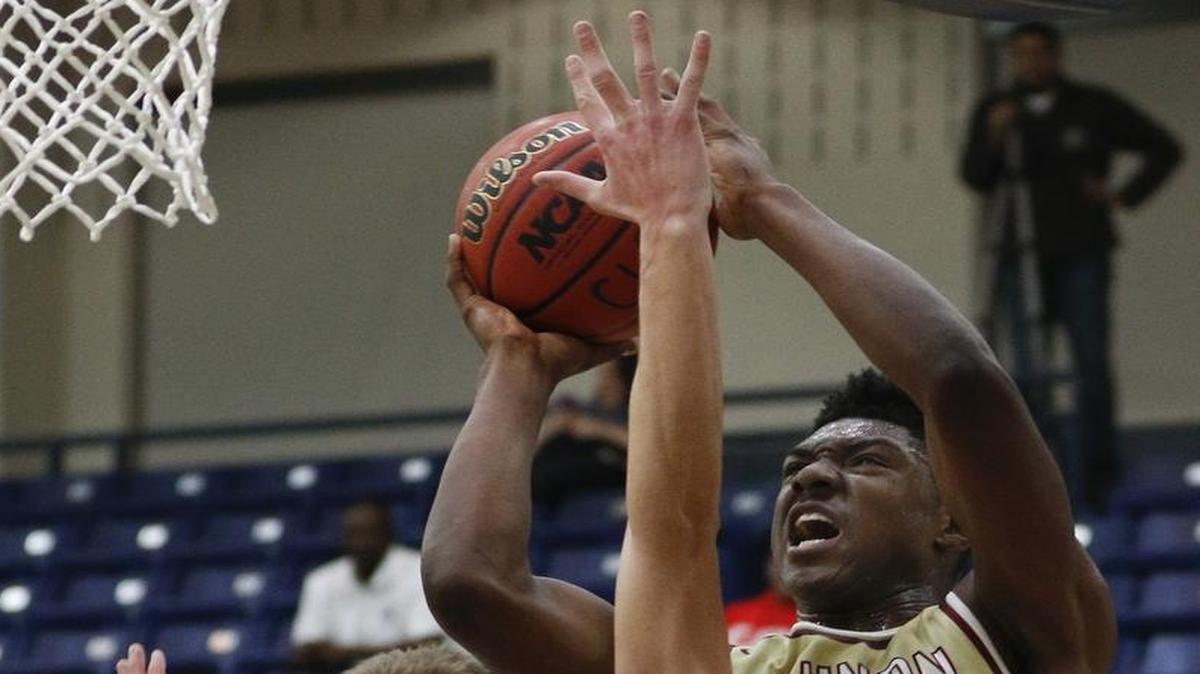 Cannon's Jairus Hamilton, right, shoots against Latin forward Bates Jones in the first half of a high school basketball game in Charlotte, N.C., Tuesday, Jan. 24, 2017. (Nell Redmond photo)