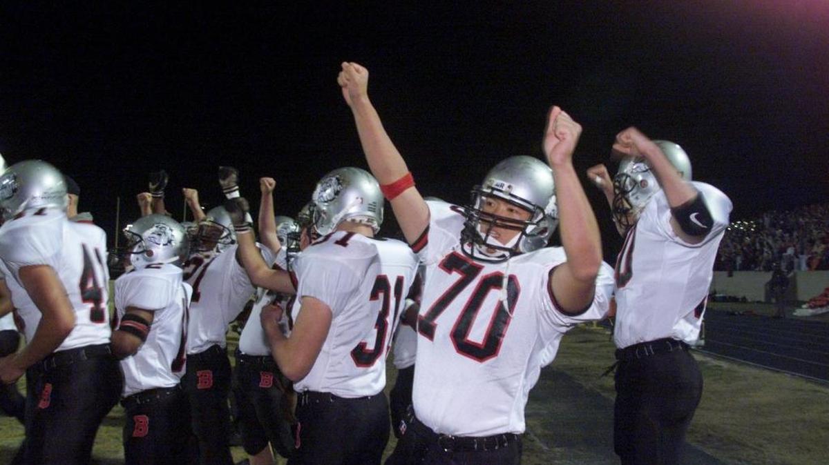 In 1999, Tony Chan (70) and other Butler players celebrate their team's second touchdown in the first half in a playoff game at Richmond Senior. Richmond won 35-20. The teams meet again Friday in Rockingham.