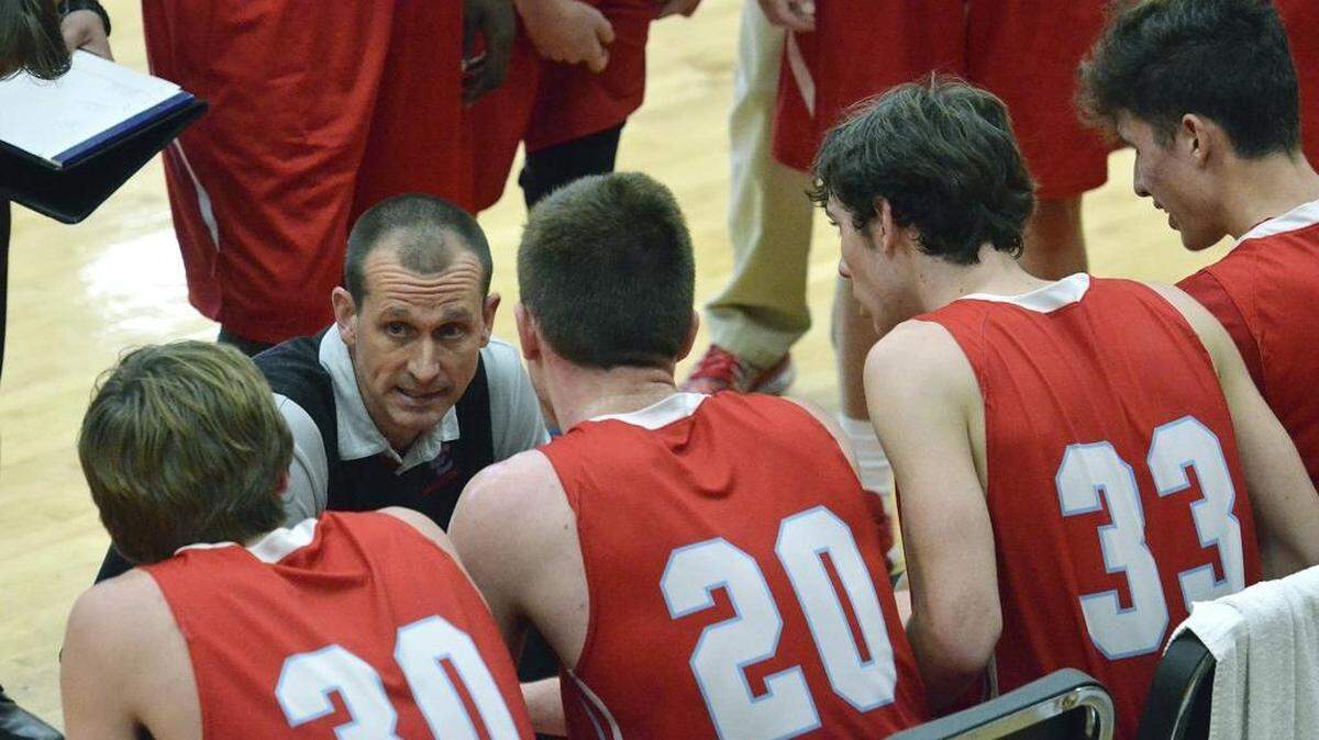 Charlotte Catholic head coach Mike King talks with his team during a second half timeout Saturday in their game against West Charlotte. Charlotte Catholic defeated West Charlotte 66-46 during the first game on Saturday at the Southeast National Hoops Festival at Vance High School.