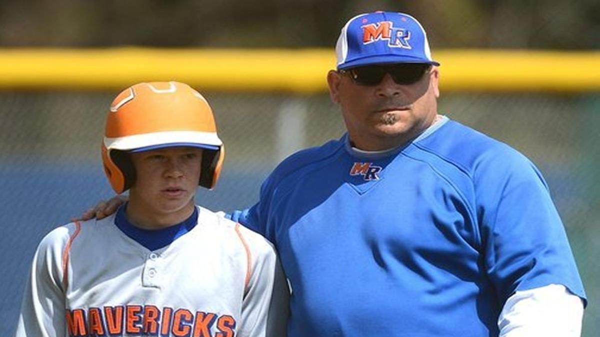 Marvin Ridge coach Mark Mennitt, right, talks with Jason Curtis prior to an at bat against Butler in the 2013 Spring Break Classic at East Mecklenburg High School.