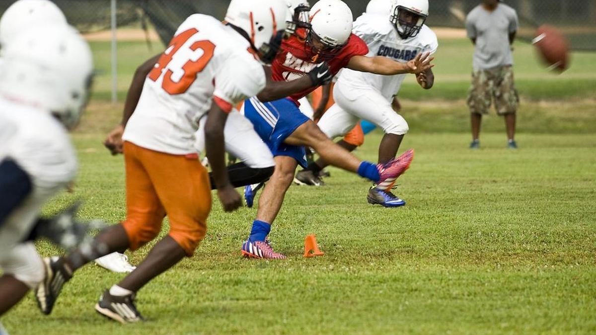 Vance High kicker Oz Alvarenga (red shirt) kicks off during a drill last season.