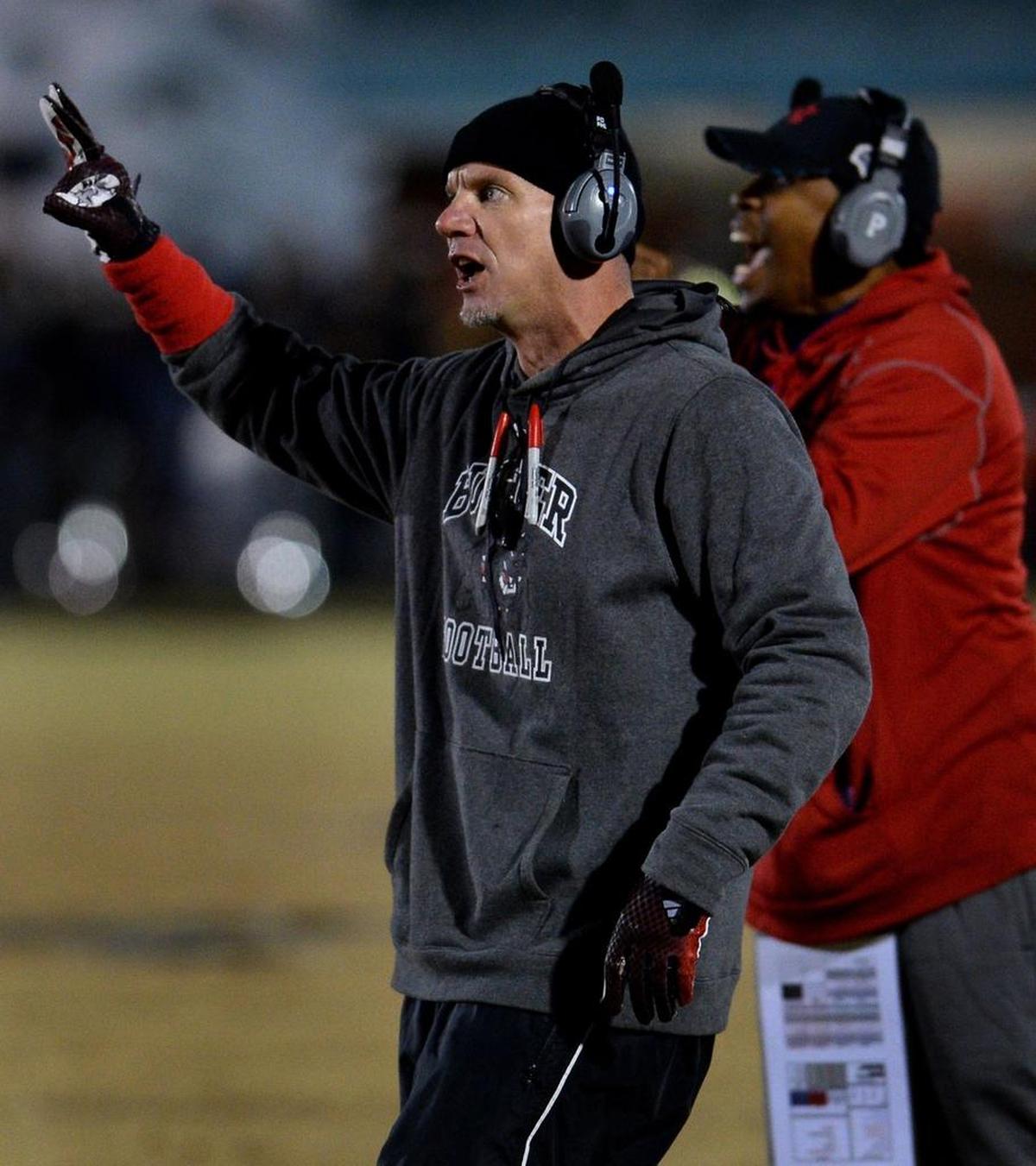 Butler Bulldogs head coach Brian Hales signals instructions to his team during first-quarter action against Myers Park on Friday, November 17, 2017 at Butler High School.