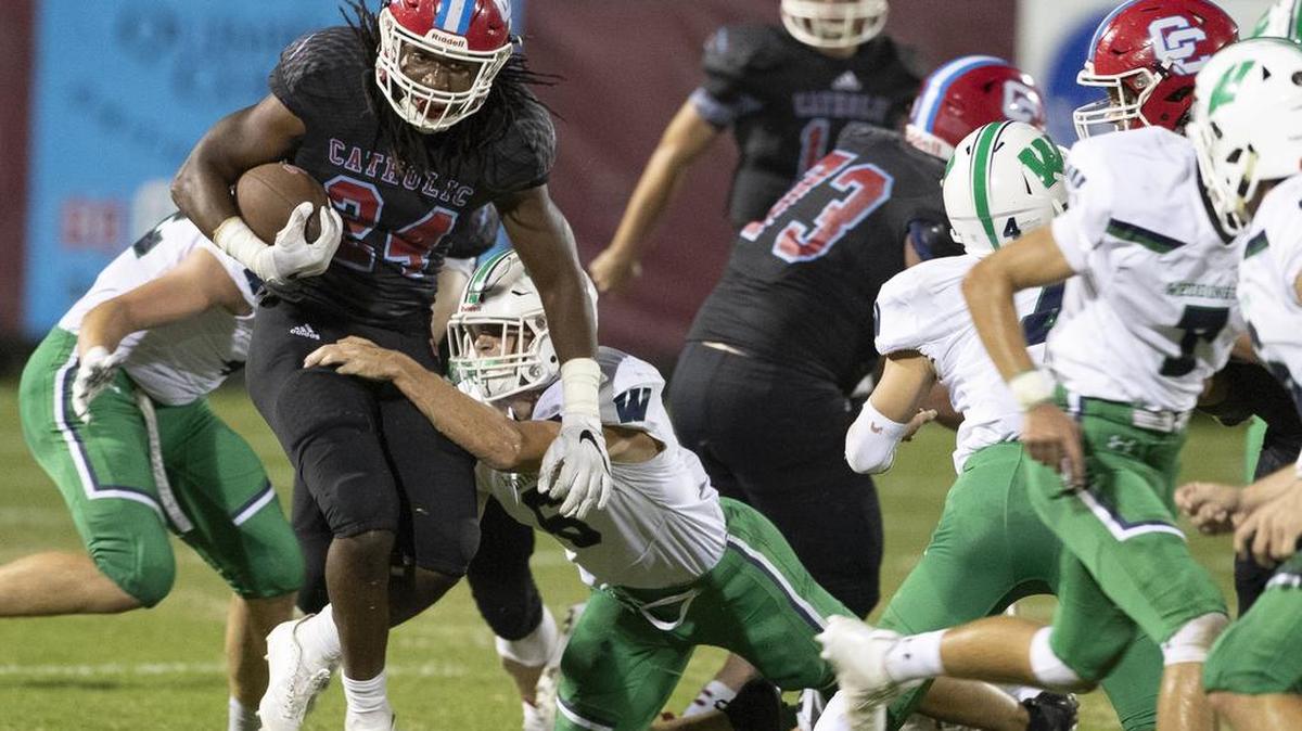 Charlotte Catholic running back Lamagea McDowell looks for running room against Weddington’s defense on Friday at Charlotte Catholic. McDowell and the Cougars won 20-0.