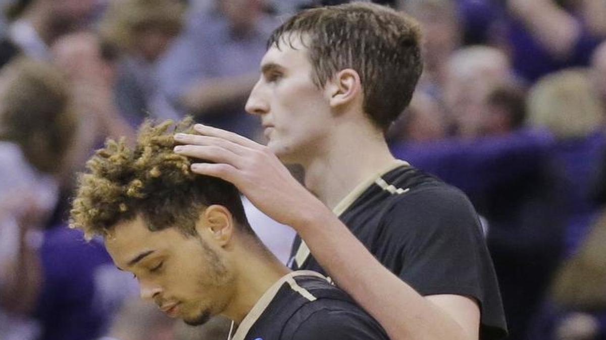 Vanderbilt's Luke Kornet, right, consoles guard Matthew Fisher-Davis (5) following the team's 68-66 loss to Northwestern in a first-round game of the NCAA men's college basketball tournament Thursday, March 16, 2017, in Salt Lake City. (AP Photo/Rick Bowmer)