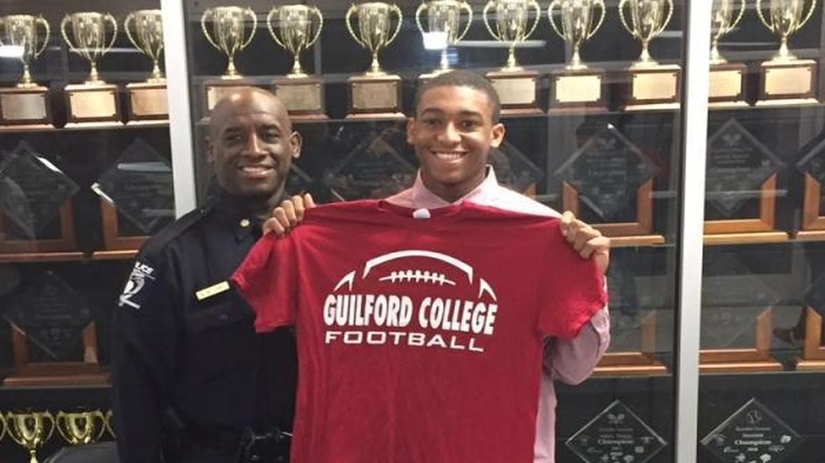 Providence High’s Caleb Bellamy (right) signed with Guilford College Friday. He’s pictured his father, Charlotte-Mecklenburg police major Bruce Bellamy. Caleb wrote a letter to high school football in November that touched many Observer readers, worried he might be playing his final high school game