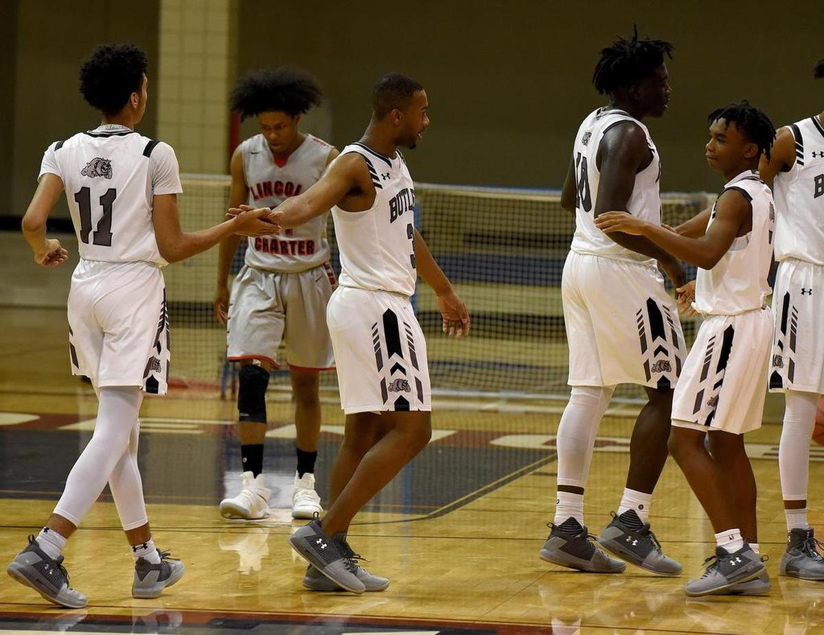 Butler players celebrate their win against Lincoln Charter in Friday night’s Hoodie’s House national tournament game at Providence Day. The Bulldogs had a 32-20 halftime lead but struggled in the third quarter, scoring only five points. Butler regained its composure in the fourth quarter to win the local/regional championship.