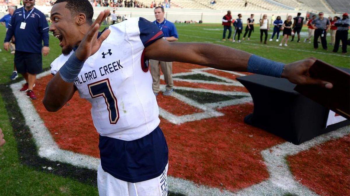 Mallard Creek quarterback James Smith reacts to teammates after accepting the championship MVP trophy Saturday following the Mavericks’ 49-6 win against Greensboro Page in the N.C. 4AA title game in Raleigh.