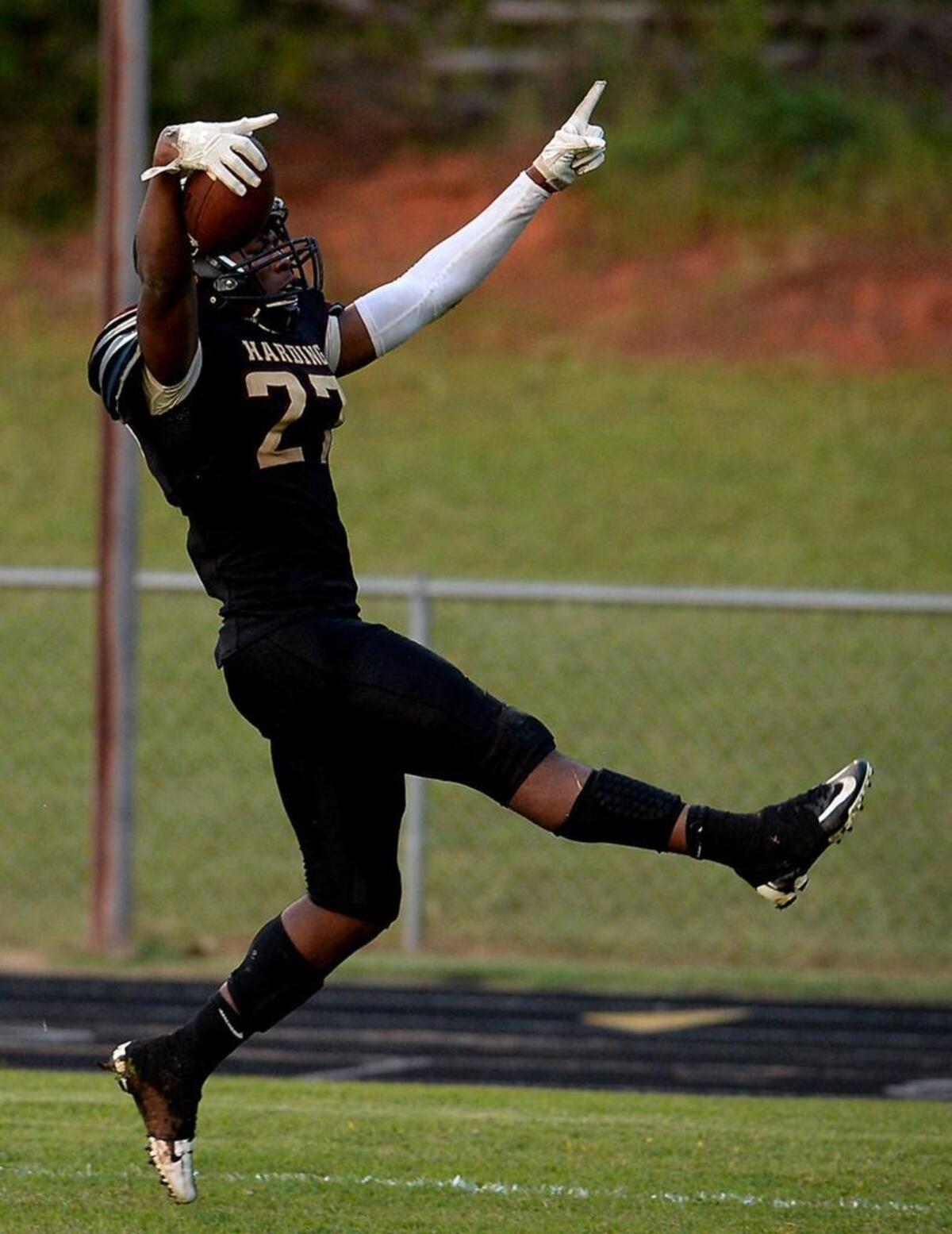 Harding running back Quavaris Crouch high steps into the end zone for a touchdown against West Charlotte last season.