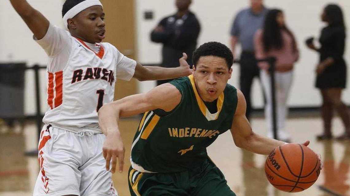 Independence guard Chea Johnson, right, drives around Rocky River's Elijah Sidbury in a boys high school basketball game in Mint Hill, N.C., Tuesday, Feb. 7, 2017. (Nell Redmond photo)