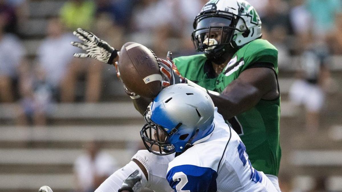 Garinger defensive back Teddy Suakollie (2) stops an intended pass for Myers Park wide receiver Elijah Bowick during a prep football game at Myers Park High School Friday, September 21, 2018 in Charlotte, NC. Photo by JASON E. MICZEK - Special to the Observer