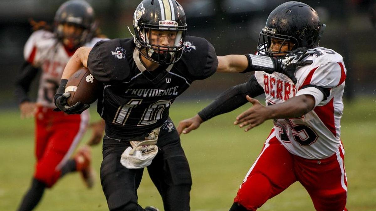 Providence receiver Blake Proehl fends off Berry defender Malcom Brown during Friday’s game.