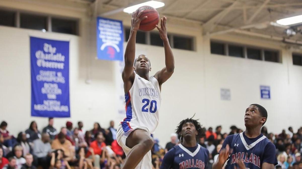 Demar Anderson (20) of North Meck drives the lane and completes the layup over two Mallard Creek defenders. The North Meck Vikings hosted the Mallard Creek Mavericks on Friday, Jan. 5, 2018.