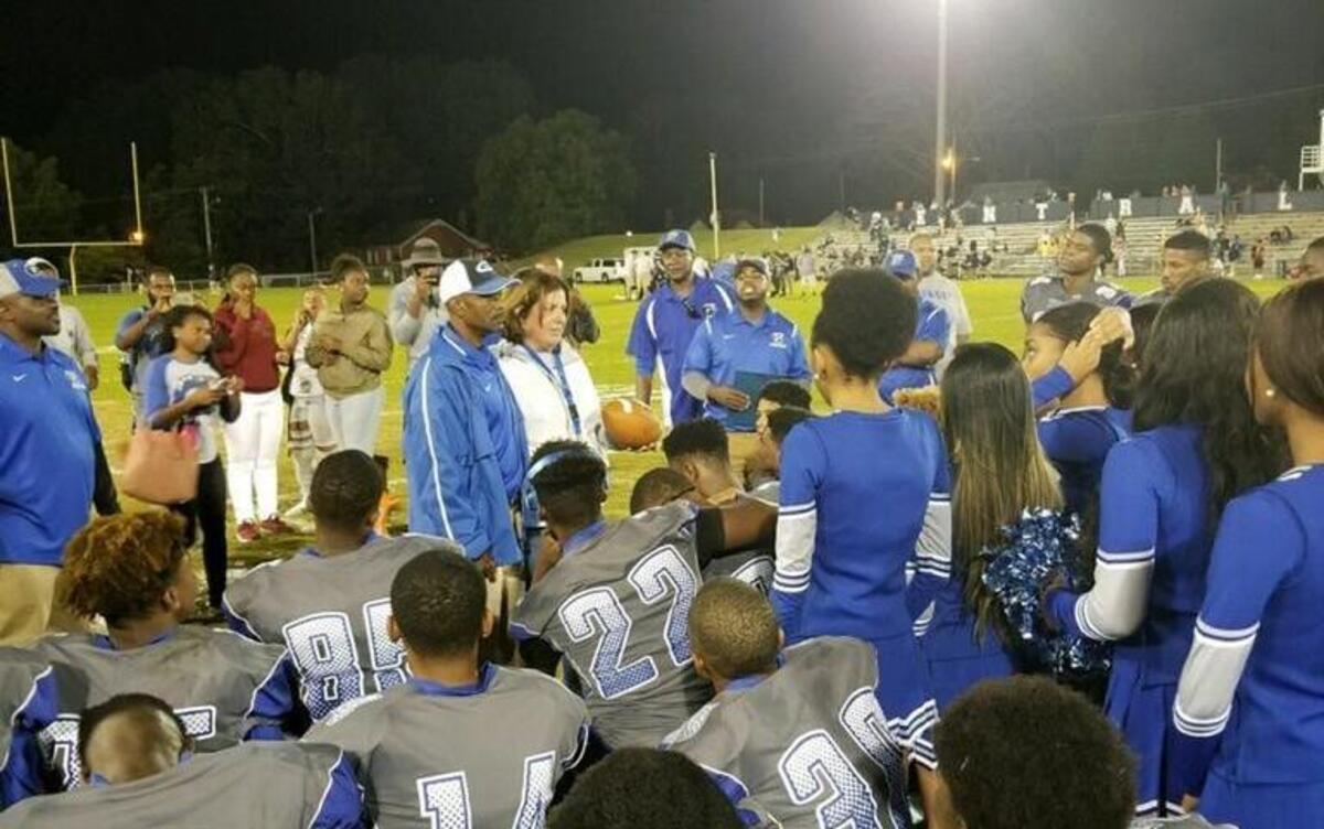 Garinger High coach Jeff Caldwell addresses his team after Garinger beat Central Academy 42-0 Friday ending its 55-game losing streak