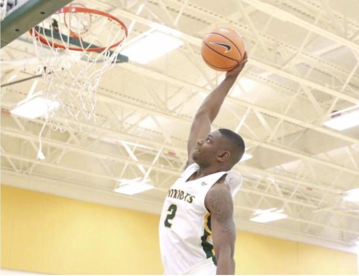 Independence High star Jamarius Burton rises for a dunk